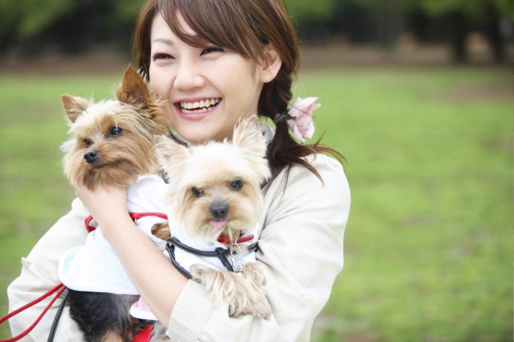 犬を抱いている女性